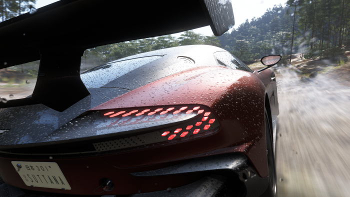 Rainy day driving a sports car on a dirt road