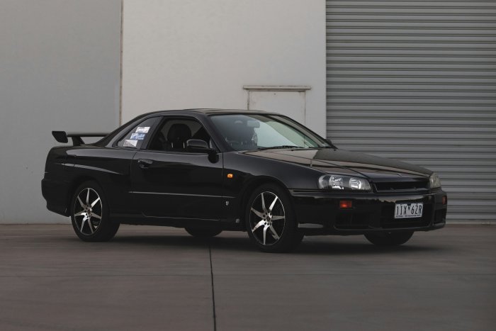 Black Nissan Skyline R34 GT-R parked outdoors
