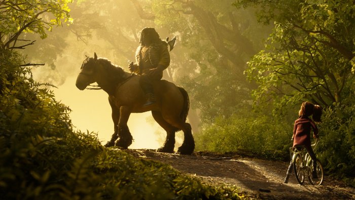 Man on horse meets girl on bicycle in forest