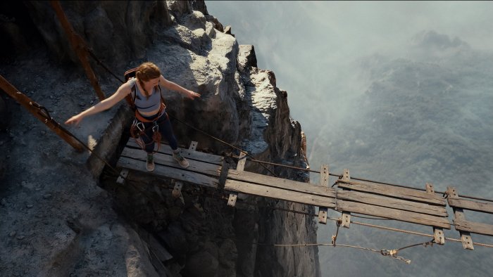 Woman on a precarious rope bridge