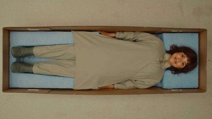 Woman in a box with blue foam padding