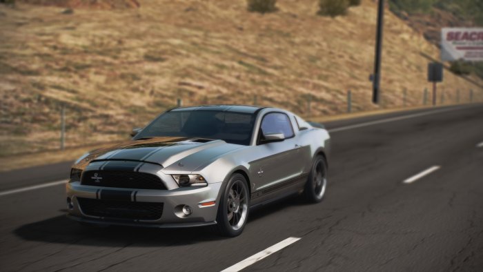 Silver Ford Mustang Shelby GT500 on a road
