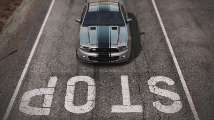 Silver Ford Mustang GT with racing stripes on a road