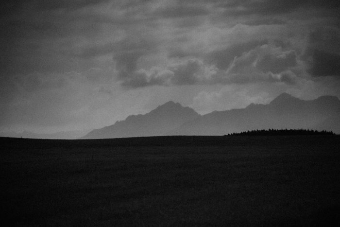 Dark, moody mountain landscape with stormy clouds