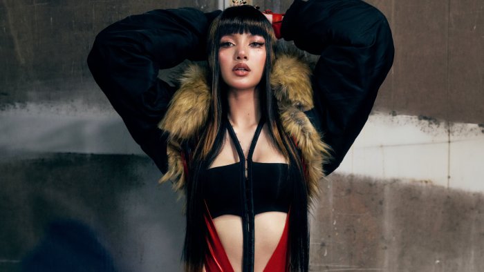 Lisa in a black outfit with fur trim