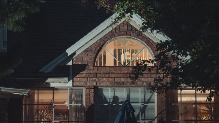House with arched window and trees