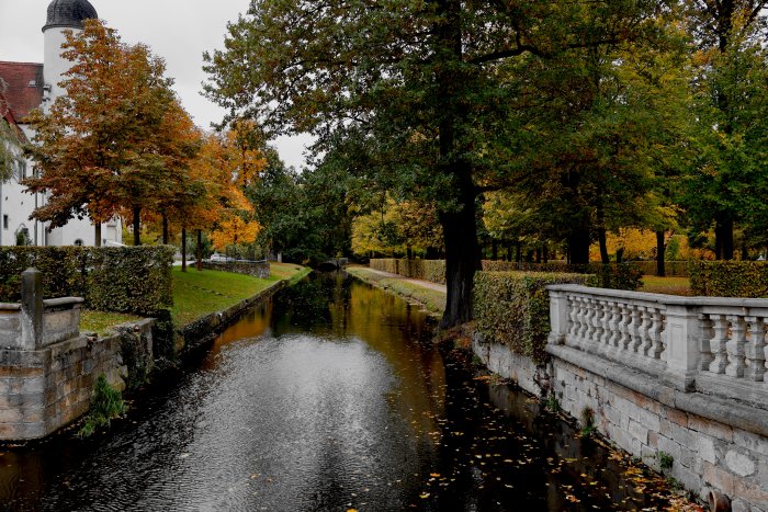 Autumn canal with trees and a building