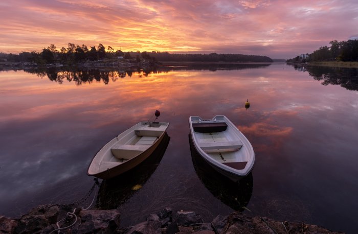 Two boats on a lake at sunset