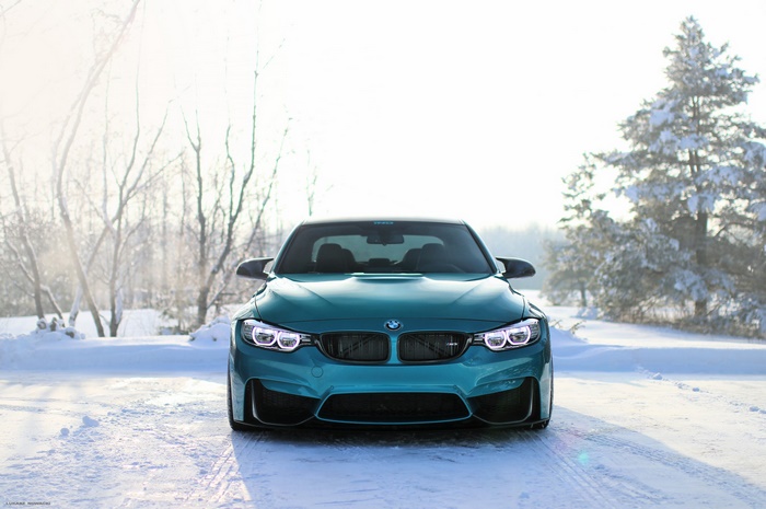 Teal BMW M4 Coupe in Snowy Landscape