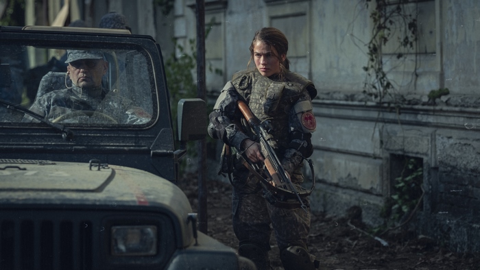 Woman with rifle and man in jeep from Tribes of Europa 4K