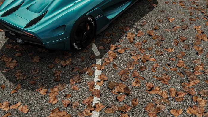 Koenigsegg Regera on asphalt with fallen leaves