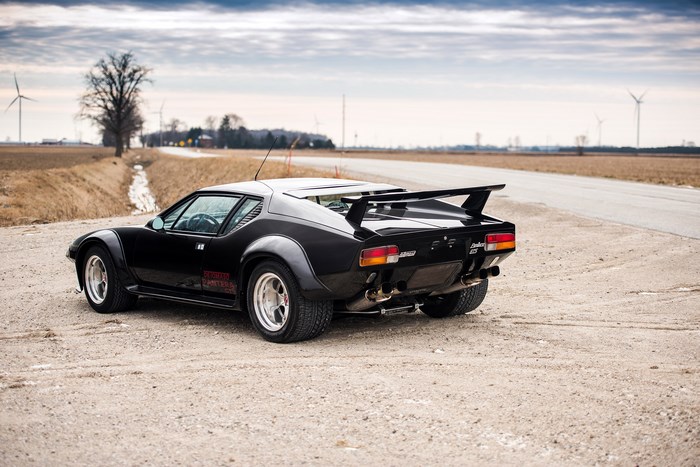 Black 1980 De Tomaso Pantera GT5 on a dirt road