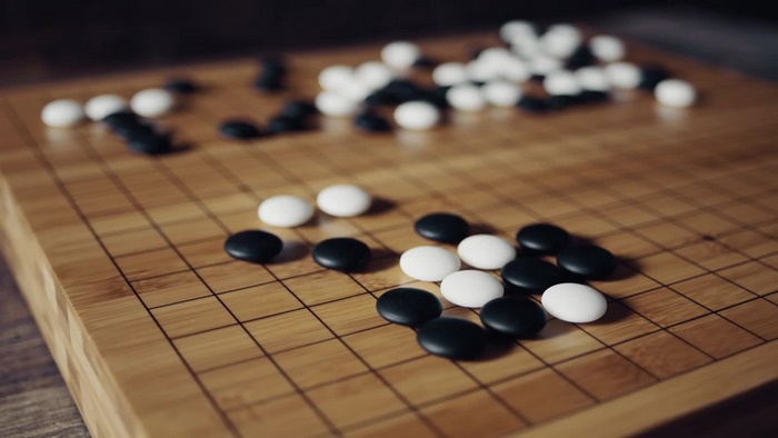 Go board with black and white stones