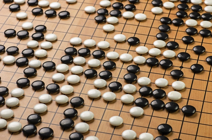 Go board with black and white stones