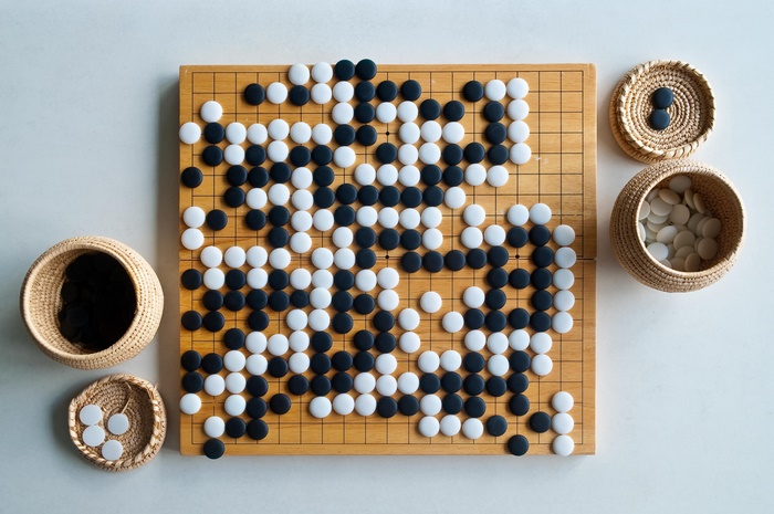 Go board game with black and white stones