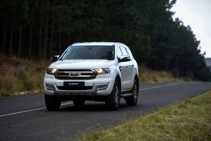 White Ford Everest SUV driving on a road