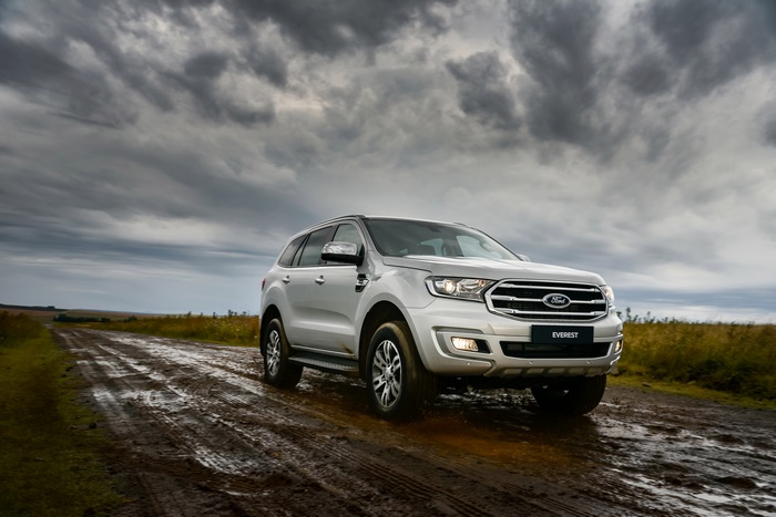 Silver Ford Everest SUV on a muddy road