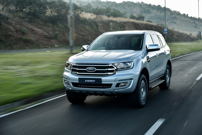 Silver Ford Everest SUV driving on a road