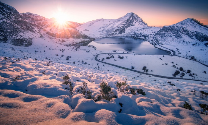 Winter Sunrise Over Snowy Mountains and Lake