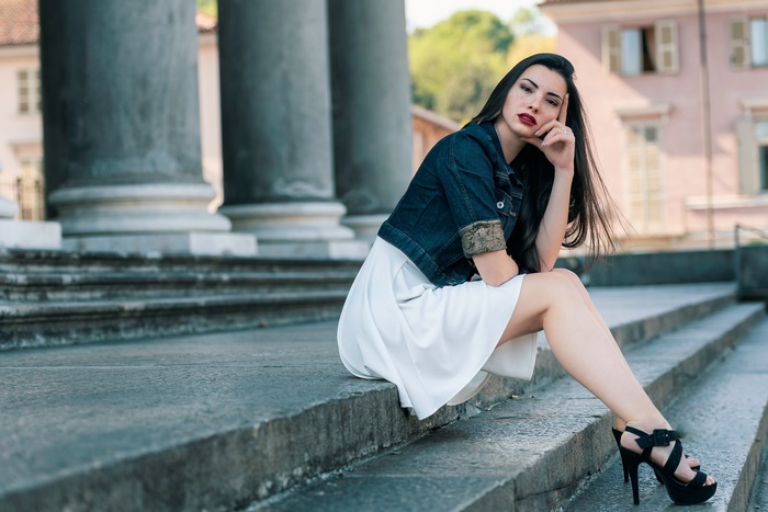 Woman in Denim Jacket Sitting on Steps