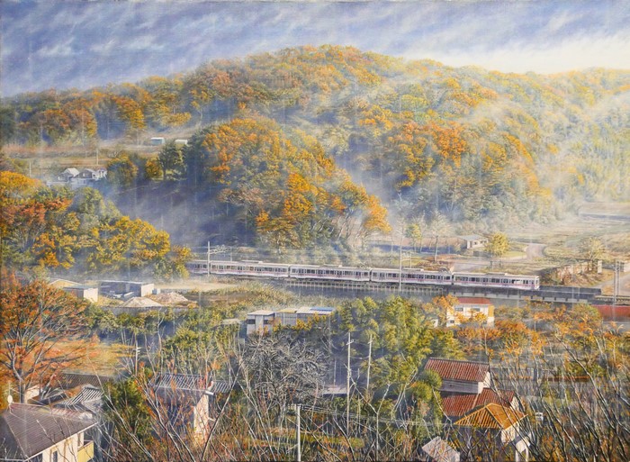 Train passing through a village in autumn