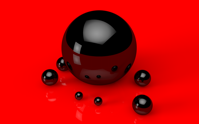 Black spheres on a red reflective surface