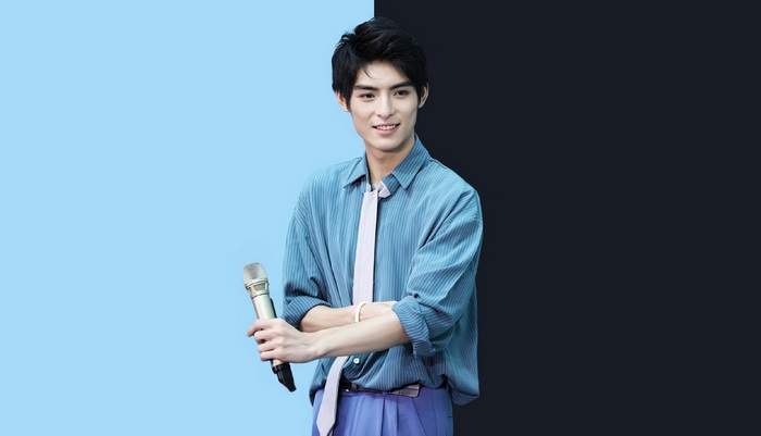 Wang Hao Xuan holding a microphone