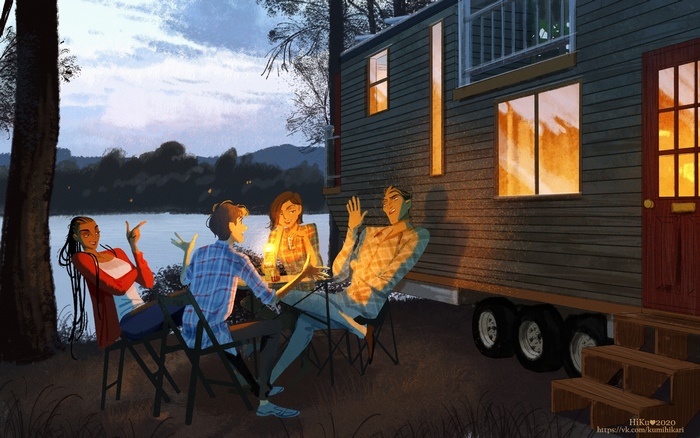 People gathered around a table near a tiny house by a lake