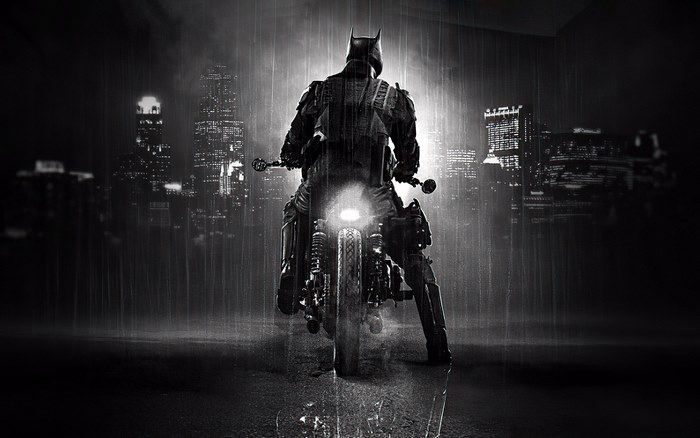 The Batman on a motorcycle in the rain
