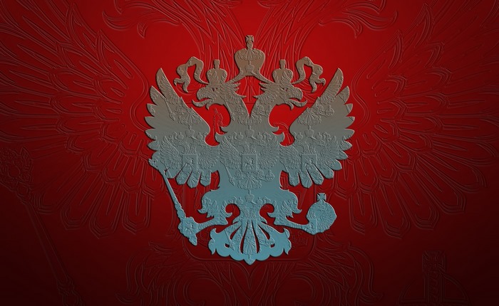 Coat of arms of Russia embossed on red background