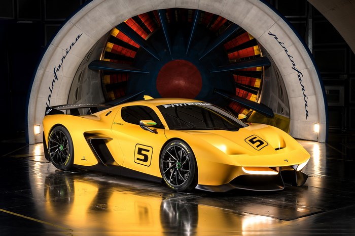 Yellow Fittipaldi EF7 race car in wind tunnel