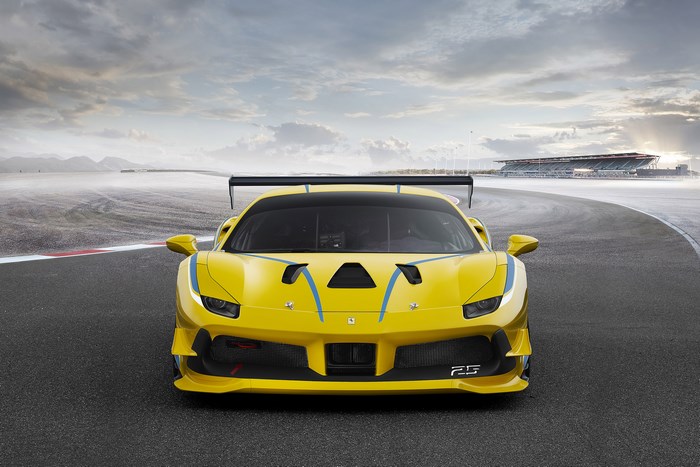 Yellow Ferrari 488 Challenge race car on track