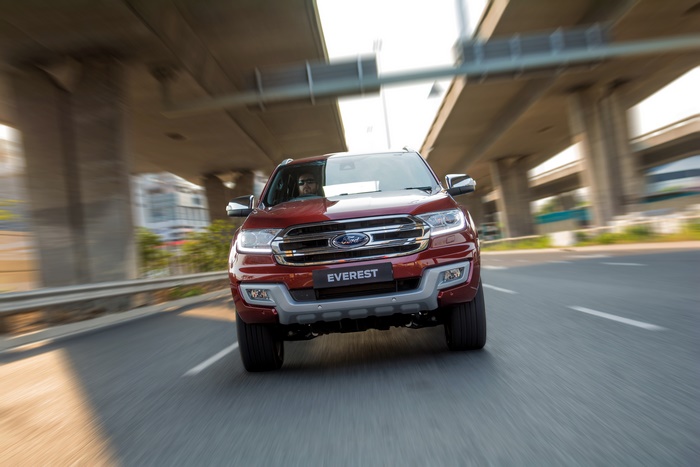 Red Ford Everest SUV driving on a highway