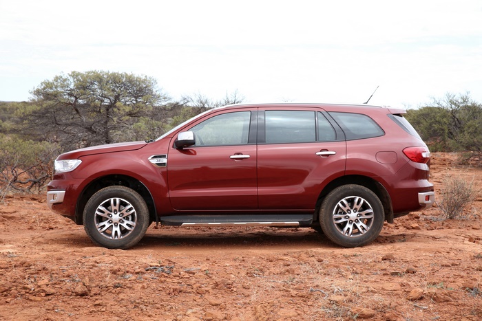 Red Ford Everest SUV parked on dirt road