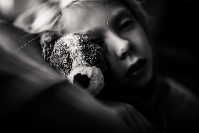 Black and White Portrait of a Child with a Teddy Bear