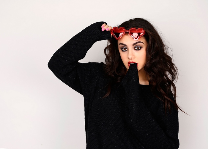 Charli XCX wearing pixelated heart sunglasses