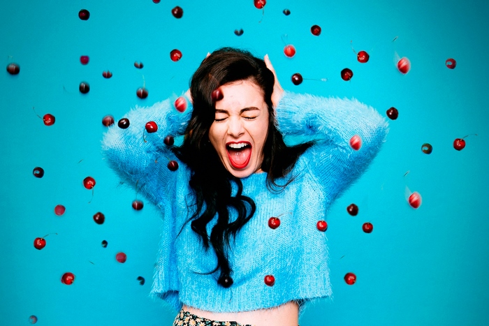 Charli XCX with cherries falling