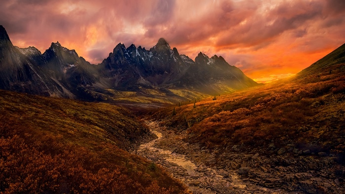 Mountain range with river at sunset