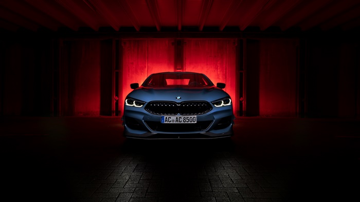 BMW 8 Series Coupe in a dark garage with red lighting