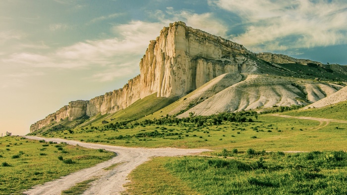 White cliff mountain with a dirt road