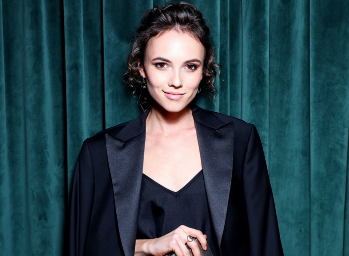 Woman with short black hair wearing a black blazer