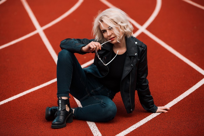 Blonde Woman in Leather Jacket on Running Track