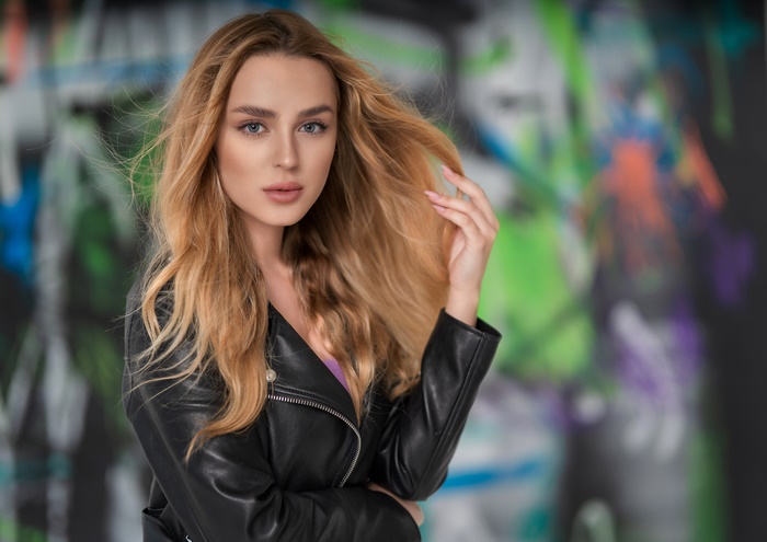 Woman with blonde hair in leather jacket