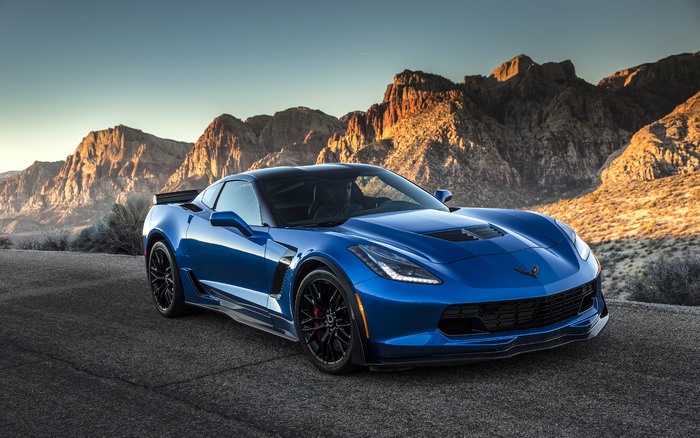 Blue 2015 Chevrolet Corvette Z06 parked on road with mountains
