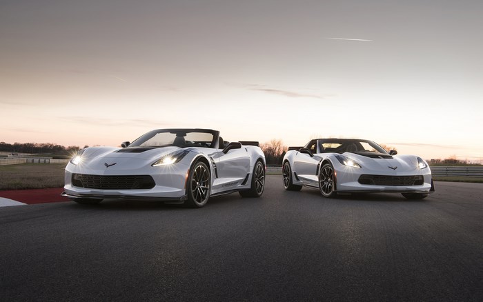 Two white Chevrolet Corvette Carbon 65 Edition convertibles on a track