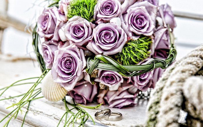 Wedding bouquet with purple roses and rings