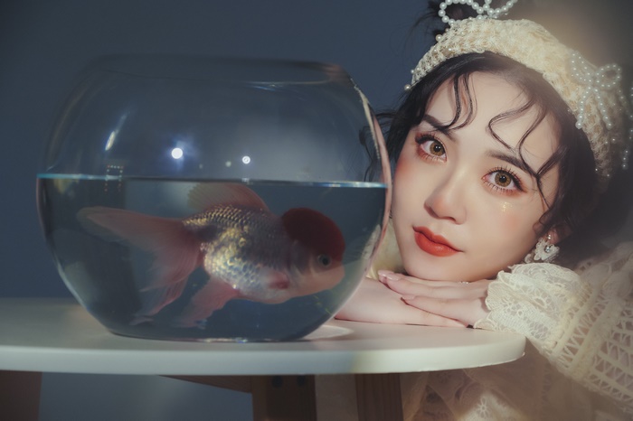 Woman with goldfish in a bowl