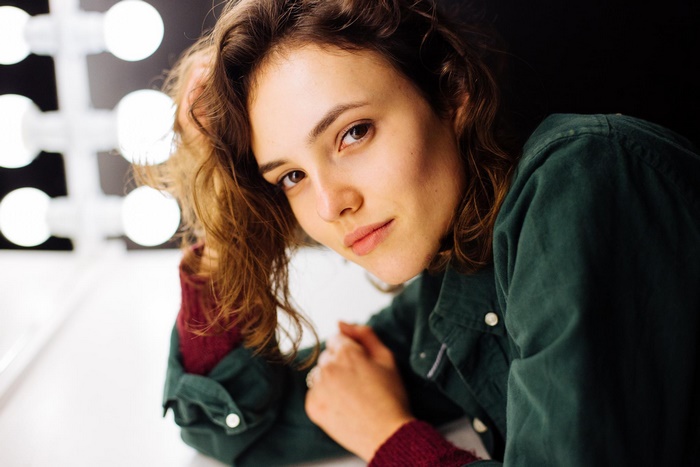 Woman with curly hair in a green shirt