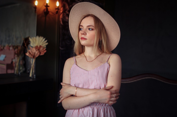 Woman wearing a hat and striped dress
