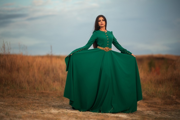 Woman in a green dress in a field
